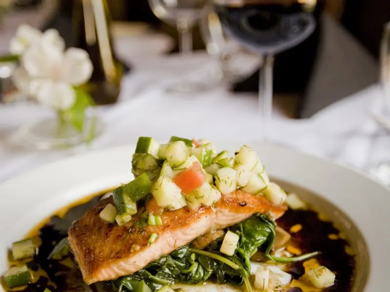 Pan-seared salmon fillet with glazed top and vegetable sides
